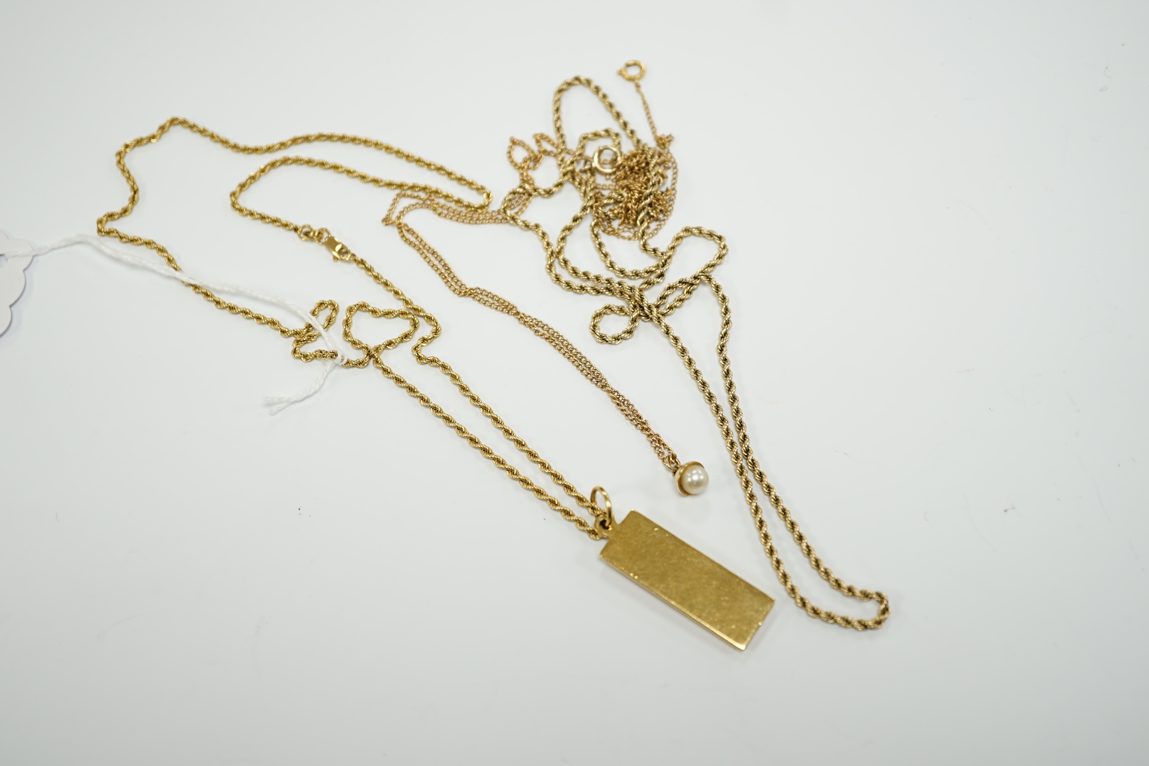 An 18ct gold ingot pendant on an 18k chain, 26.7 grams and two 9ct chains, one with cultured pearl pendant, gross weight 16.8 grams.